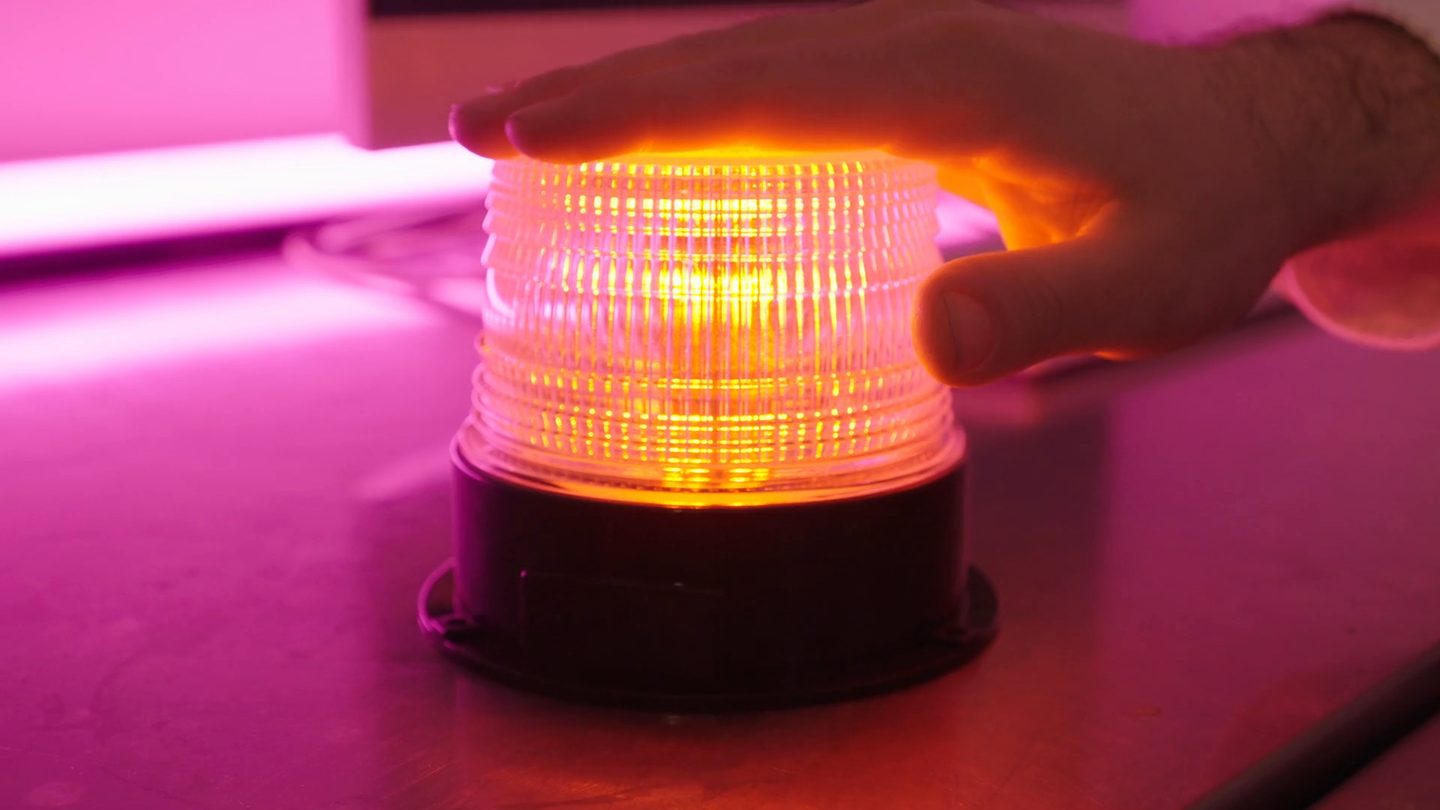 An orange rotating alarm beacon